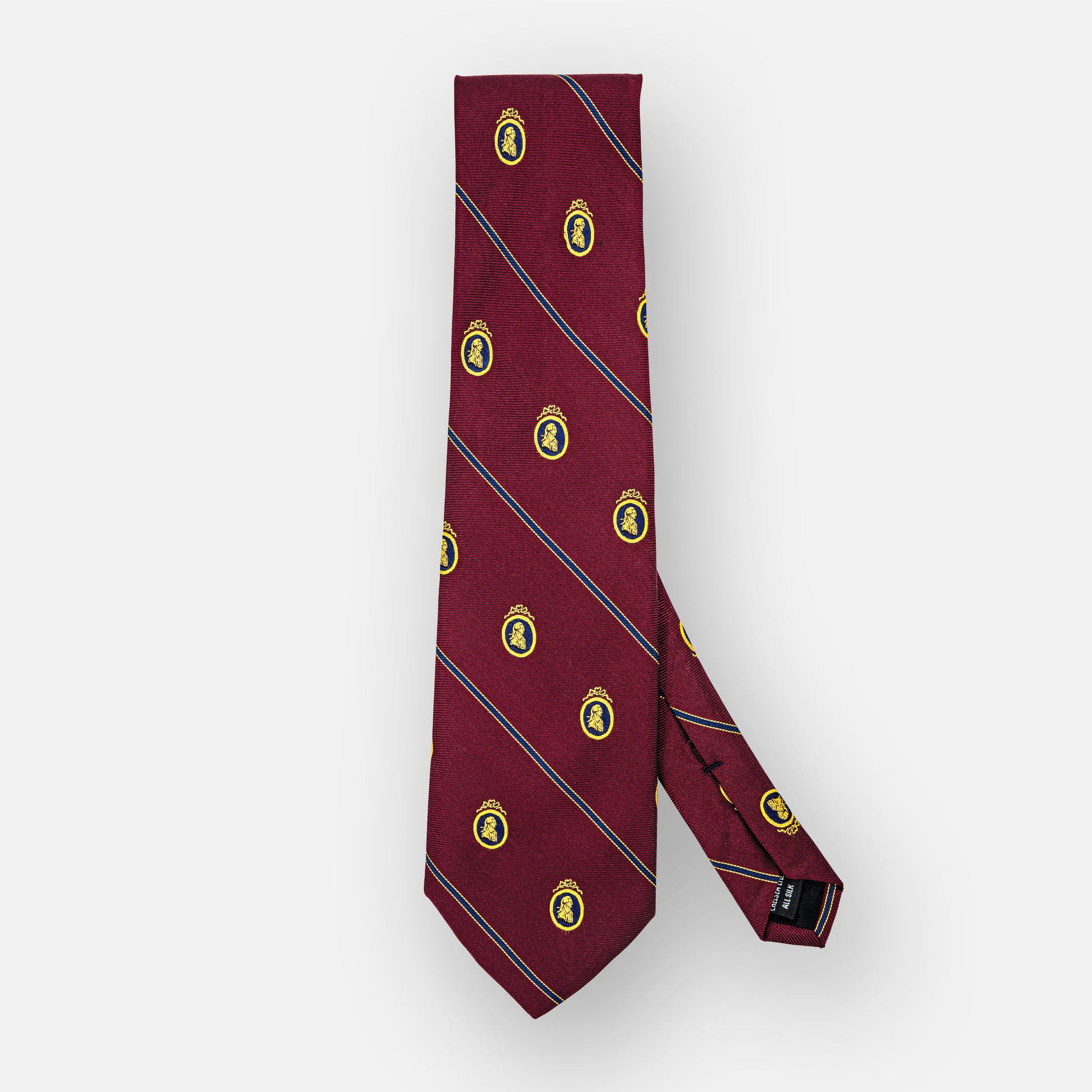 Burgundy silk tie with thin navy stripes and blue/gold portrait.