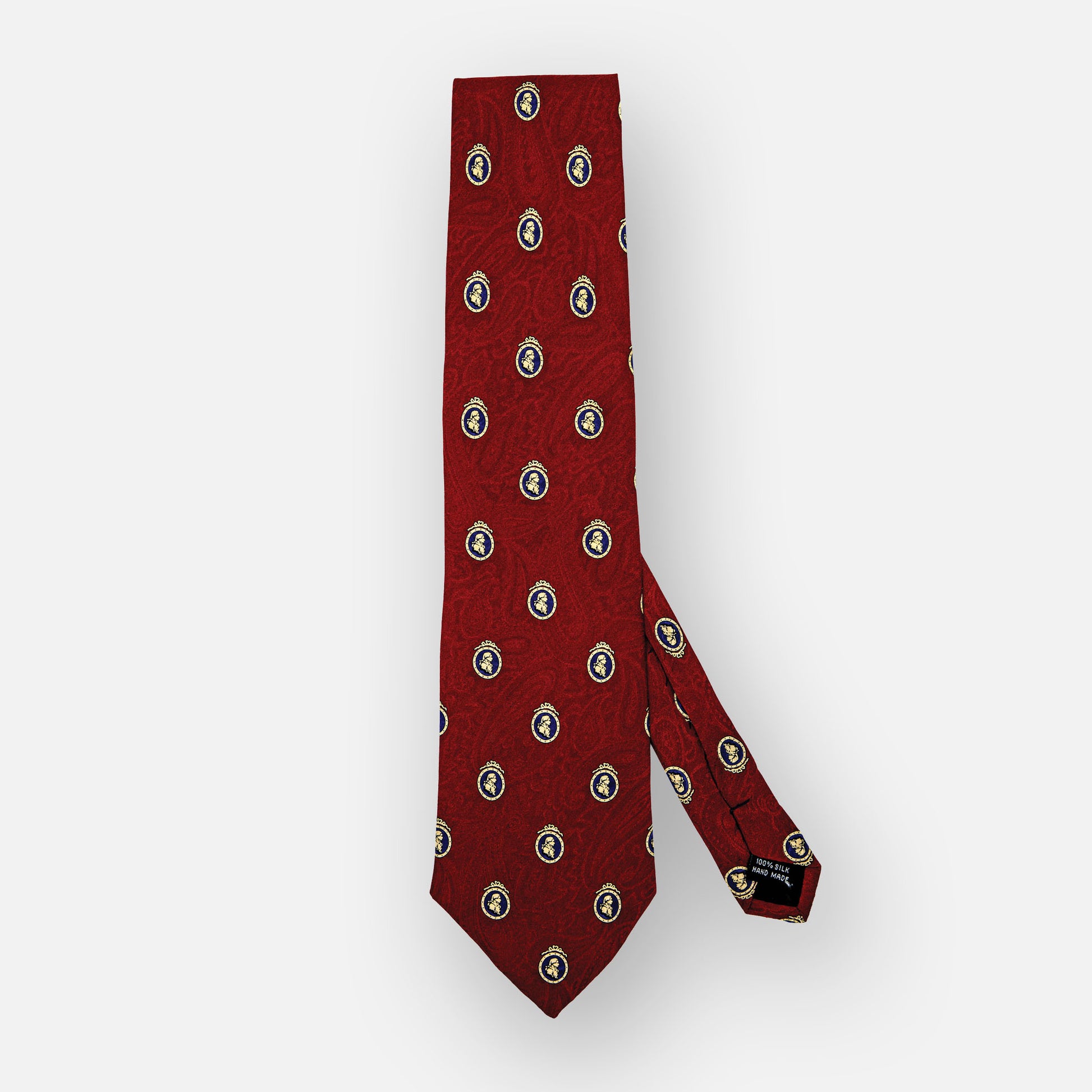 Brick red silk tie with paisley pattern and blue/ivory portrait.