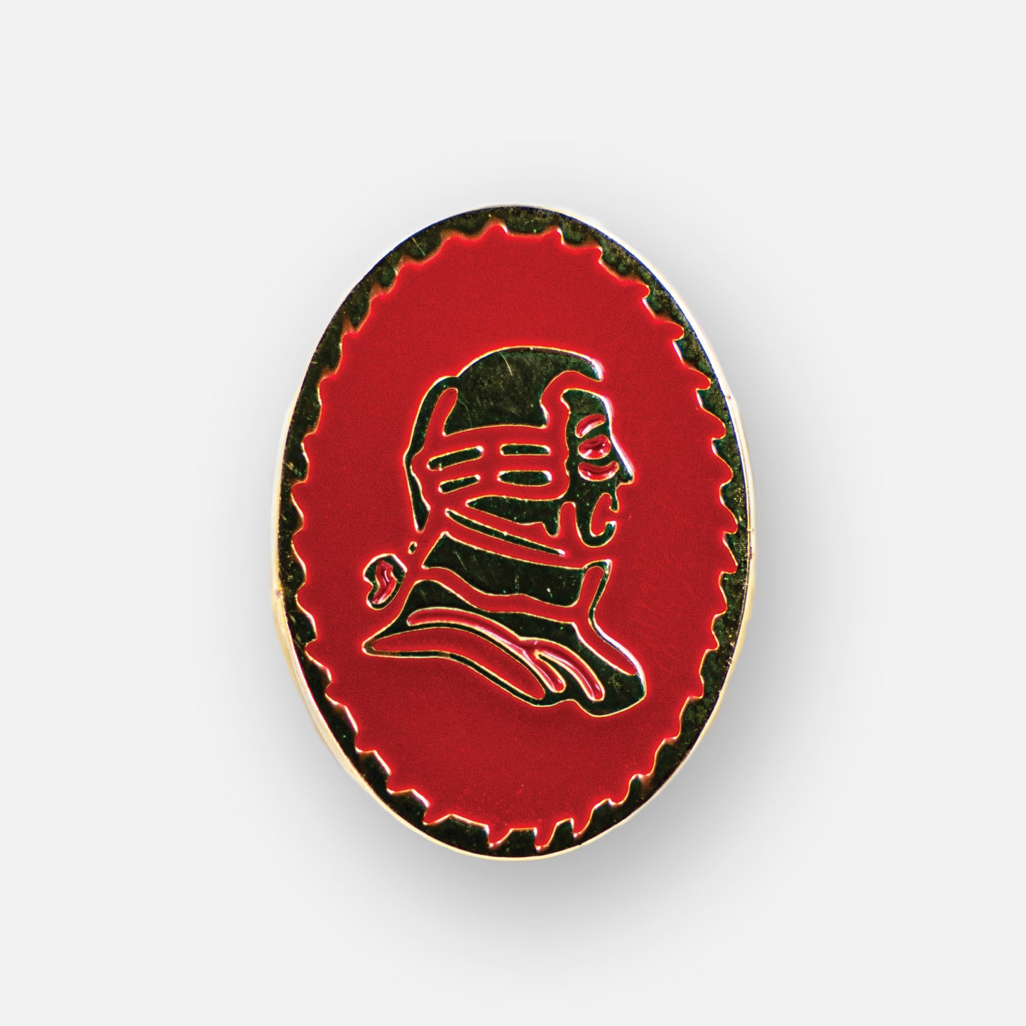 Lapel pin with red background and gold portrait.
