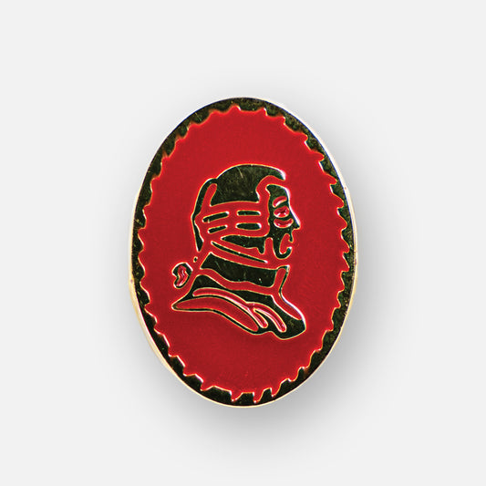 Lapel pin with red background and gold portrait.