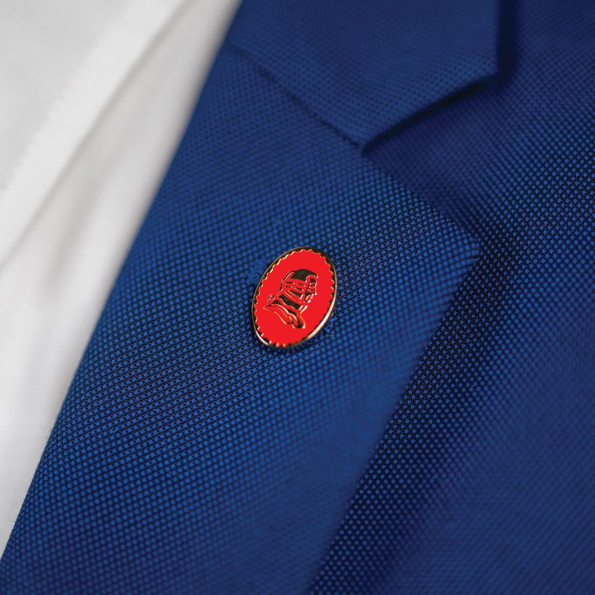 Red pin on a blue suit jacket.