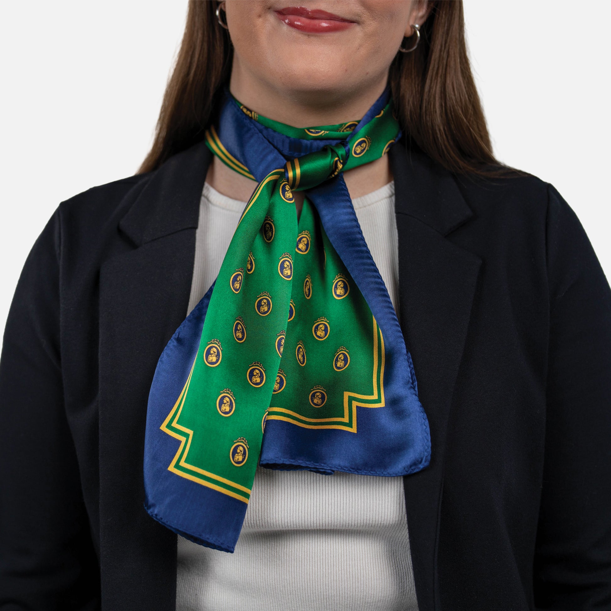 Woman wearing a green and blue patterned scarf with a white background