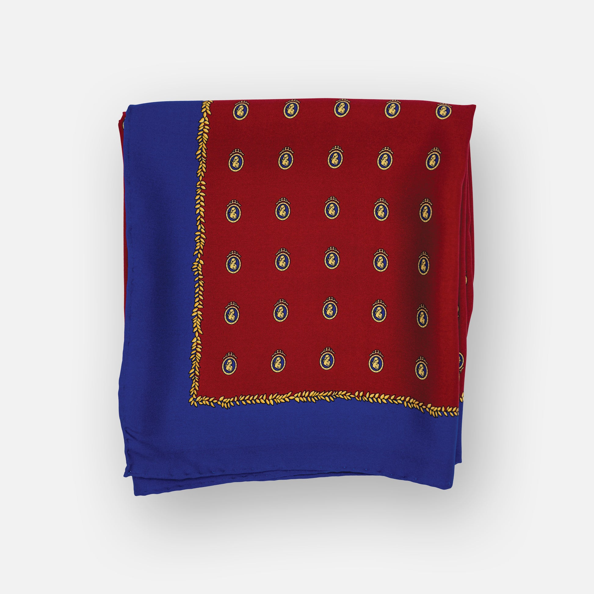 Folded red and blue scarf with gold patterns on a white background