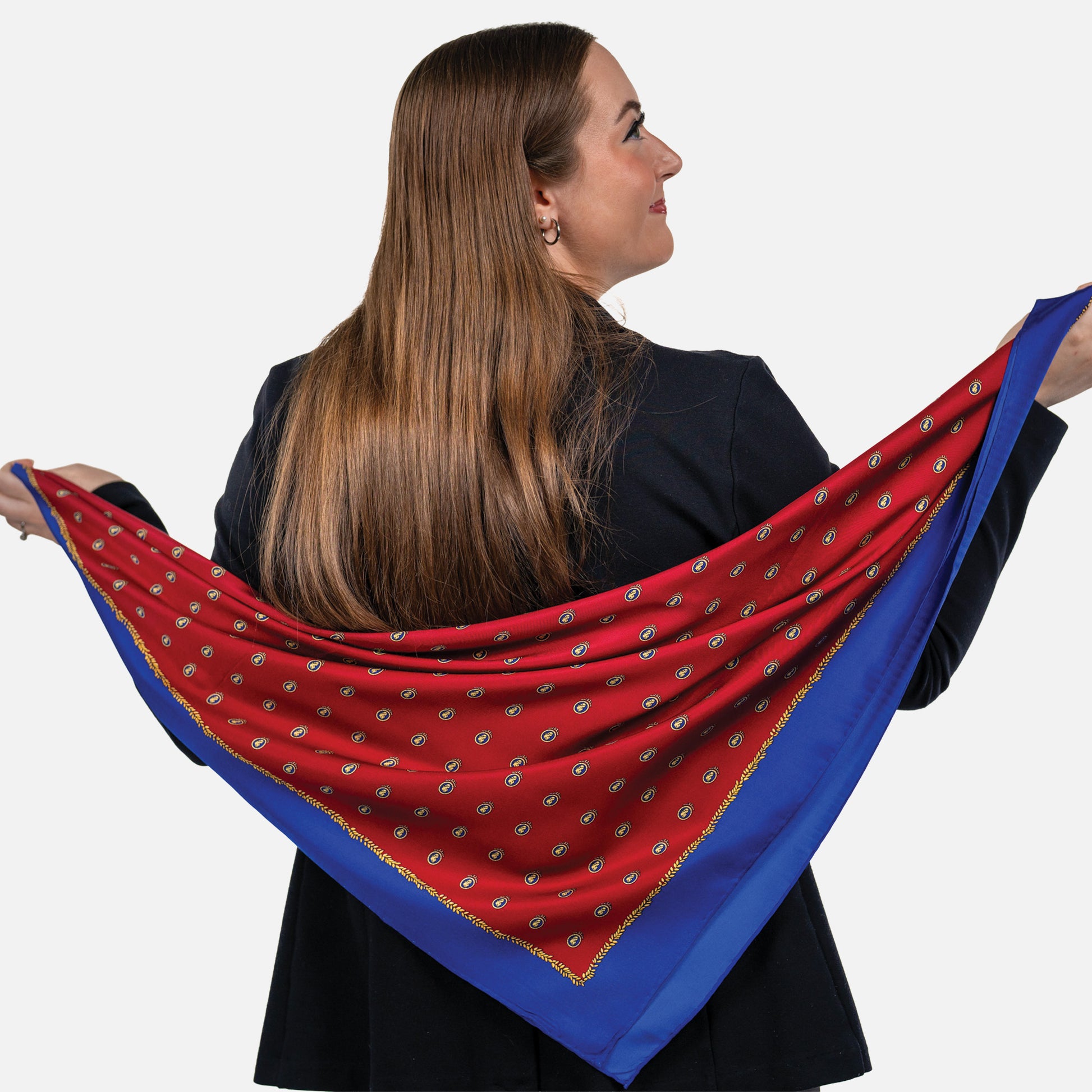 Woman holding a red and blue patterned scarf against a white background